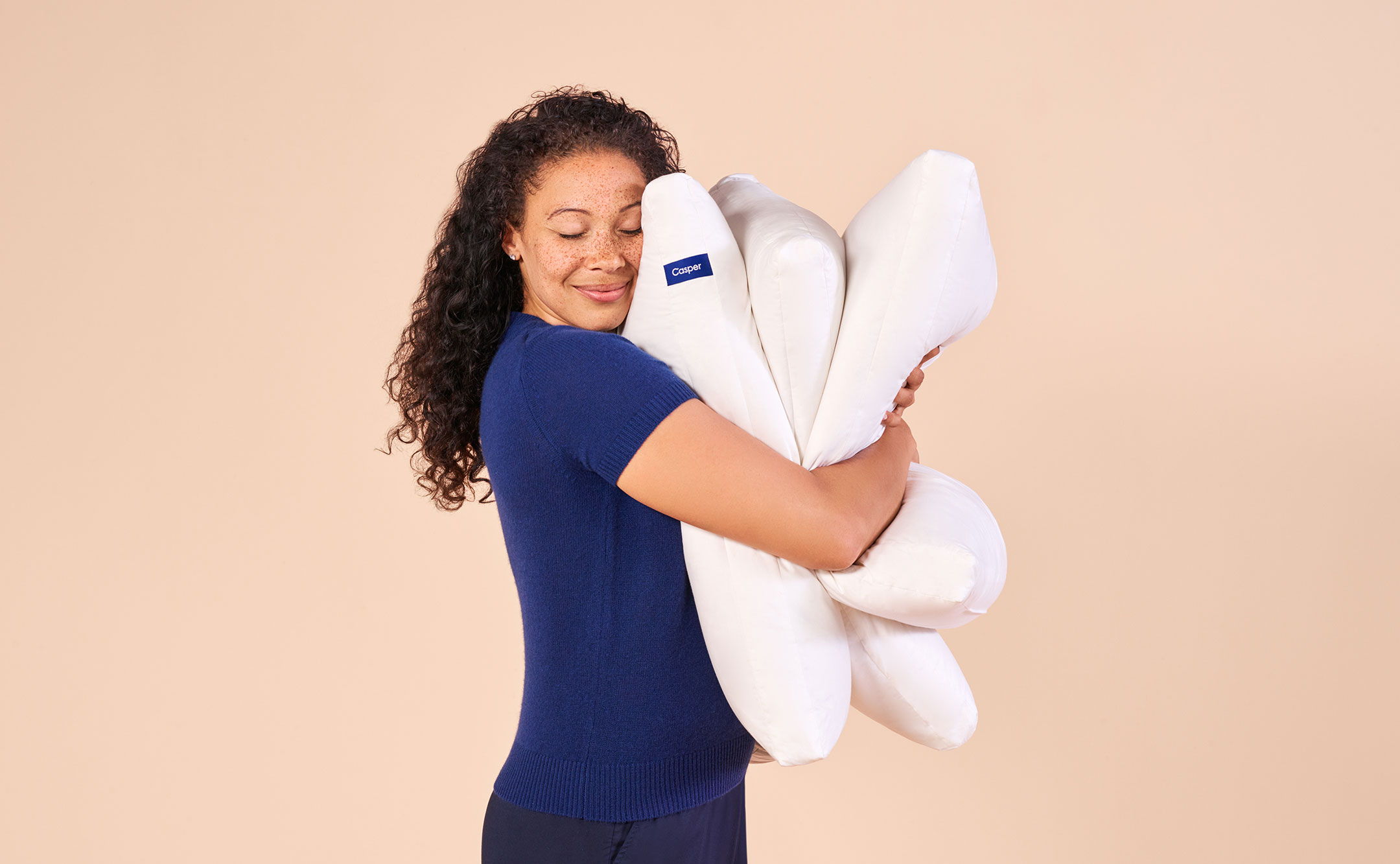 woman hugging pillows
