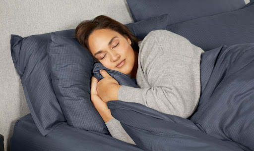 Woman sleeping peacefully in soft bed
