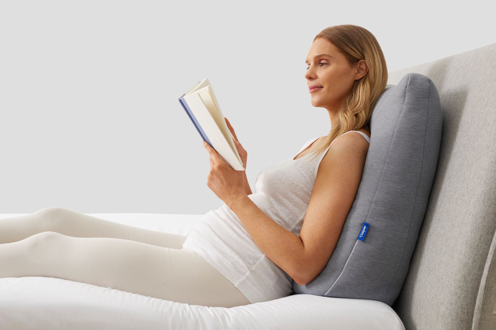 pregnant woman leaning on back pillow and reading