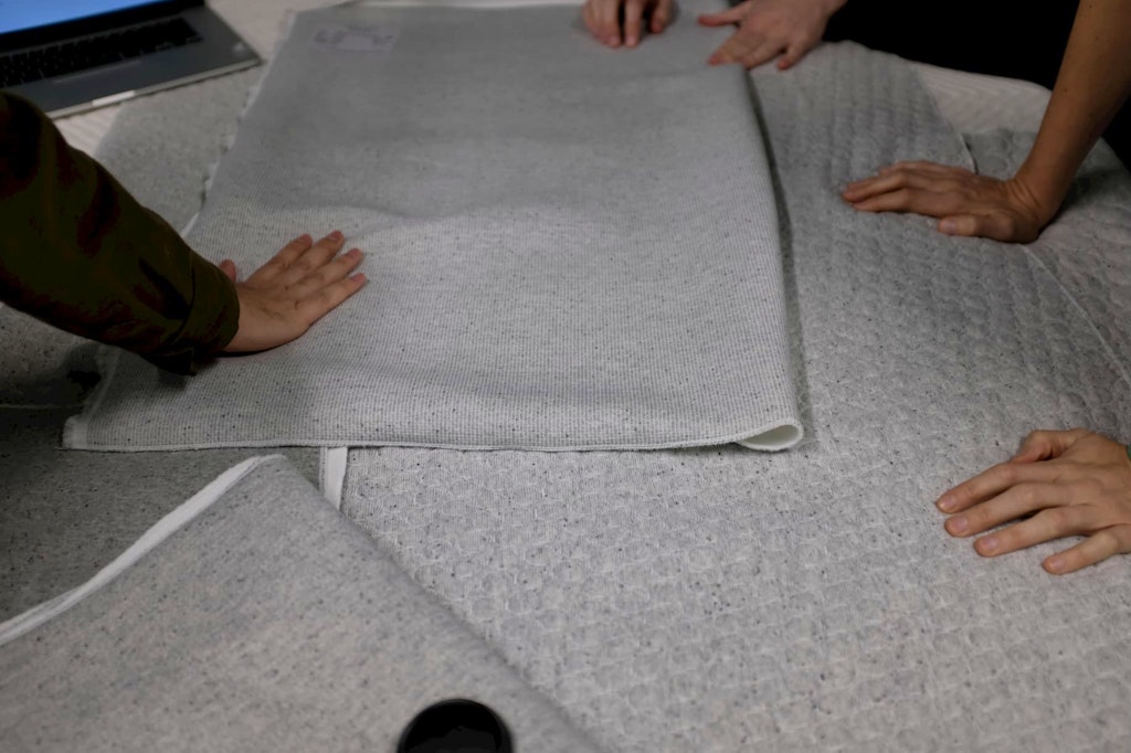 People handling textiles at Casper Labs