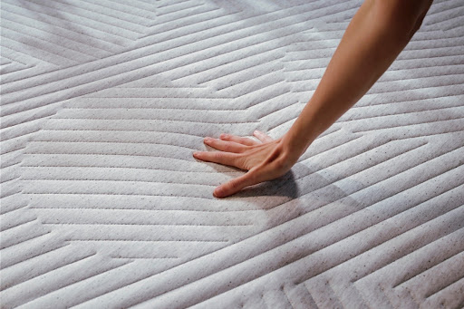 Woman's hand pushing the mattress