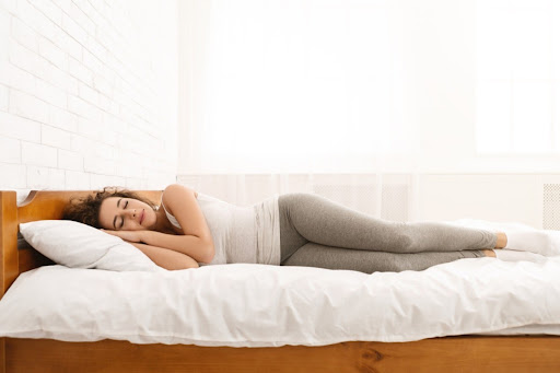 Woman sliping peaceful on her side in bed