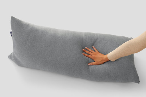 womans hand pressing body pillow